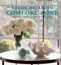 Book cover of Comfort Zone: Creating the Eco-Elegant Interior, with a vase of large white roses on a table. Published by Pointed Leaf Press.