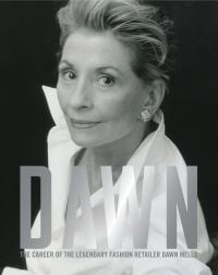Book cover of Dawn: The Career of the Legendary Fashion Retailer Dawn Mello, with the American fashion retail executive wearing a large white shirt. Published by Pointed Leaf Press.