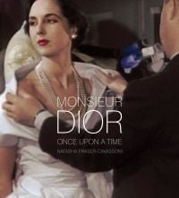 Book cover of Monsieur Dior: Once Upon a Time, with a model being fitted with a large white dress. Published by Pointed Leaf Press.