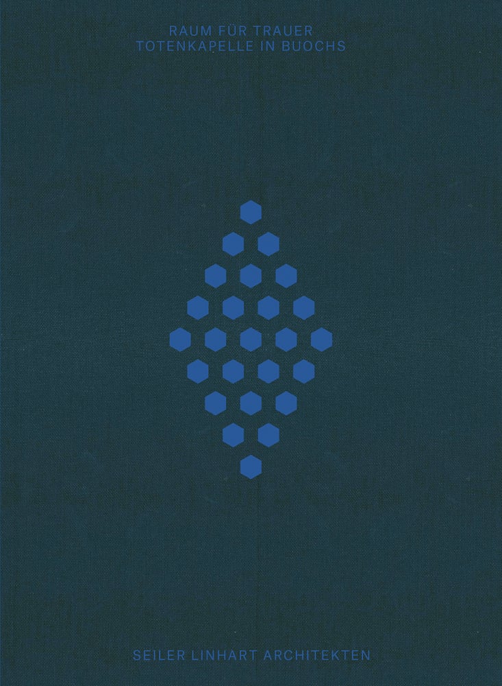 Diamond made of small blue hexagonal shapes, to centre of dark blue cover, RAUM FUR TRAUER TOTENKAPELLE IN BUOCHS in blue font above.