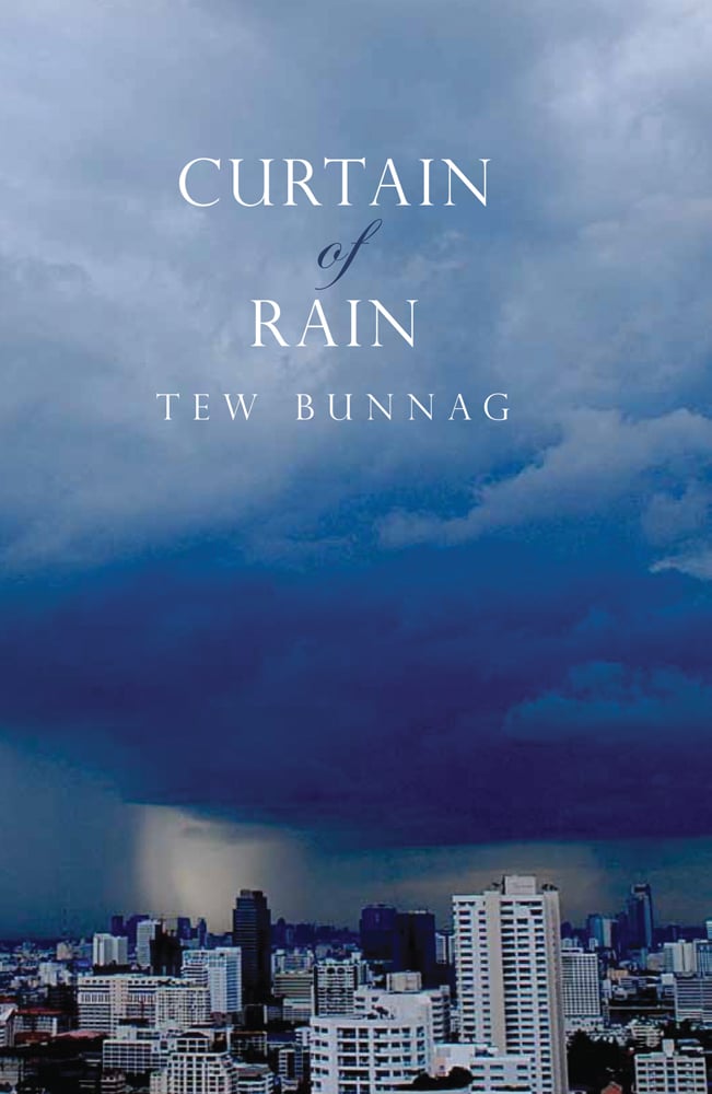 Blue moody skyline over cityscape of Bangkok, on cover of 'Curtain of Rain', by River Books.