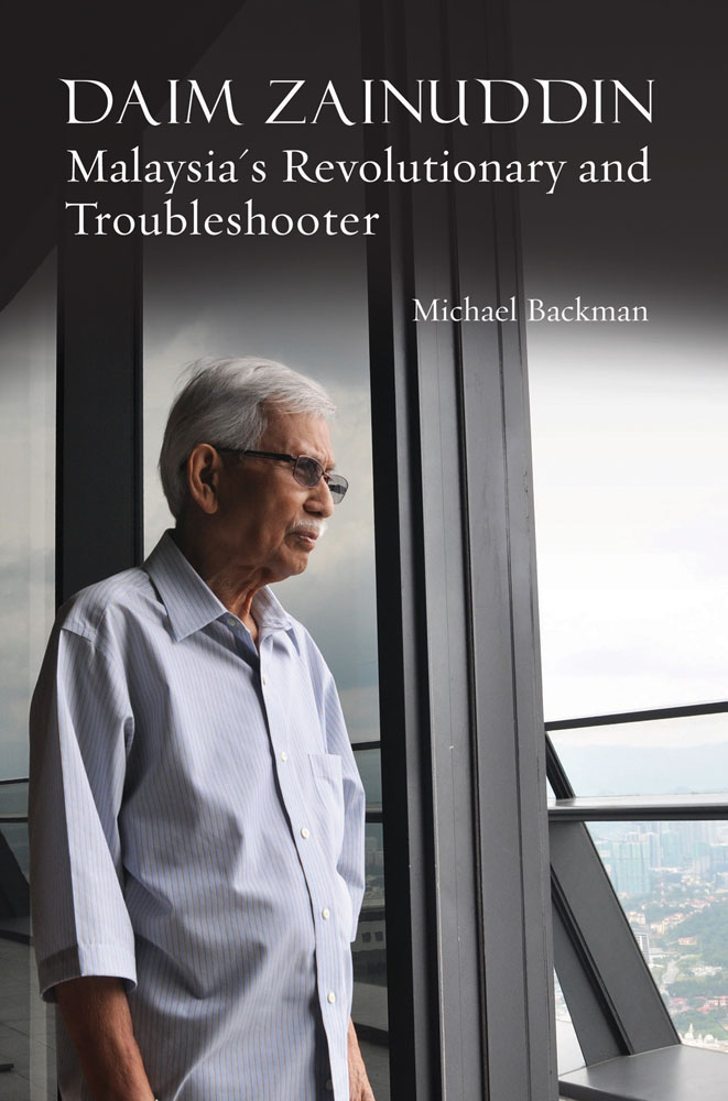 Daim Zainuddin looking out of high-rise window, to cover of 'Malaysia's Revolutionary and Troubleshooter', by River Books.