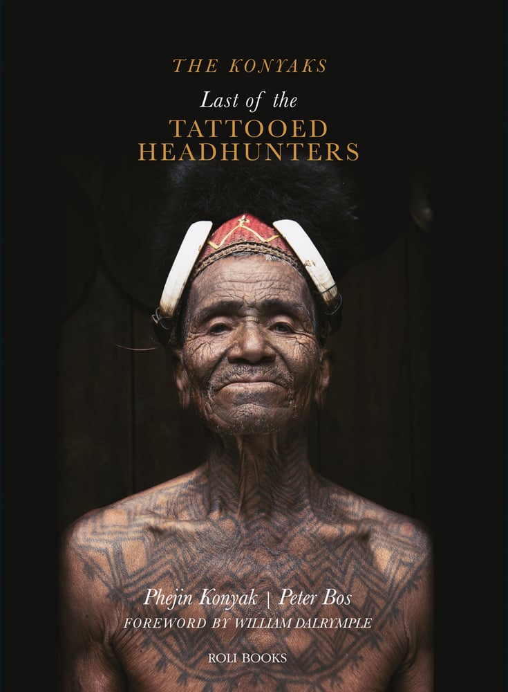 Tattooed Konyak headhunter with headdress, on black cover, The Konyaks Last of the TATTOOED HEADHUNTERS in yellow and white font above