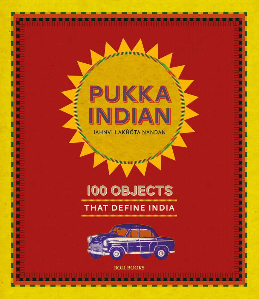 Yellow sun with Pukka Indian in 3D purple and red font, on Indian red cover, Hindustan Ambassador in blue below