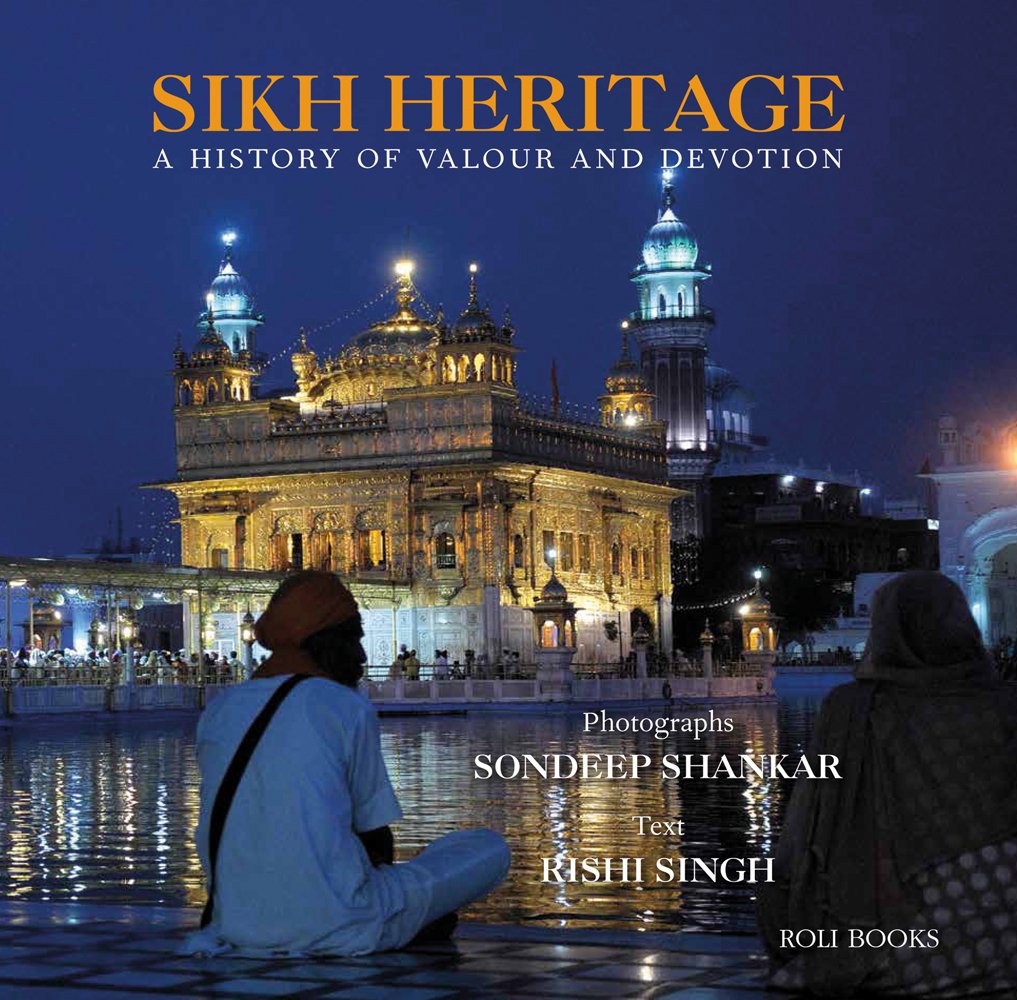 The Golden Temple in Punjab, India, illuminated under night sky, male Sikh in white kurtah and orange turban, sitting in foreground, SIKH HERITAGE in orange font above.
