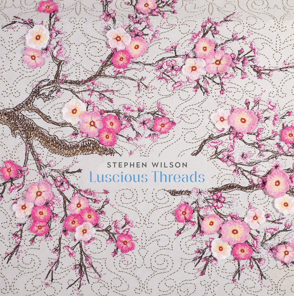 Embroidered tree with pink blossom tree, off white cover, Stephen Wilson Luscious Threads in grey and blue font to centre