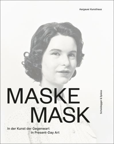 Female model with prosthetic mask, on white cover, MASKE MASK in black font below.
