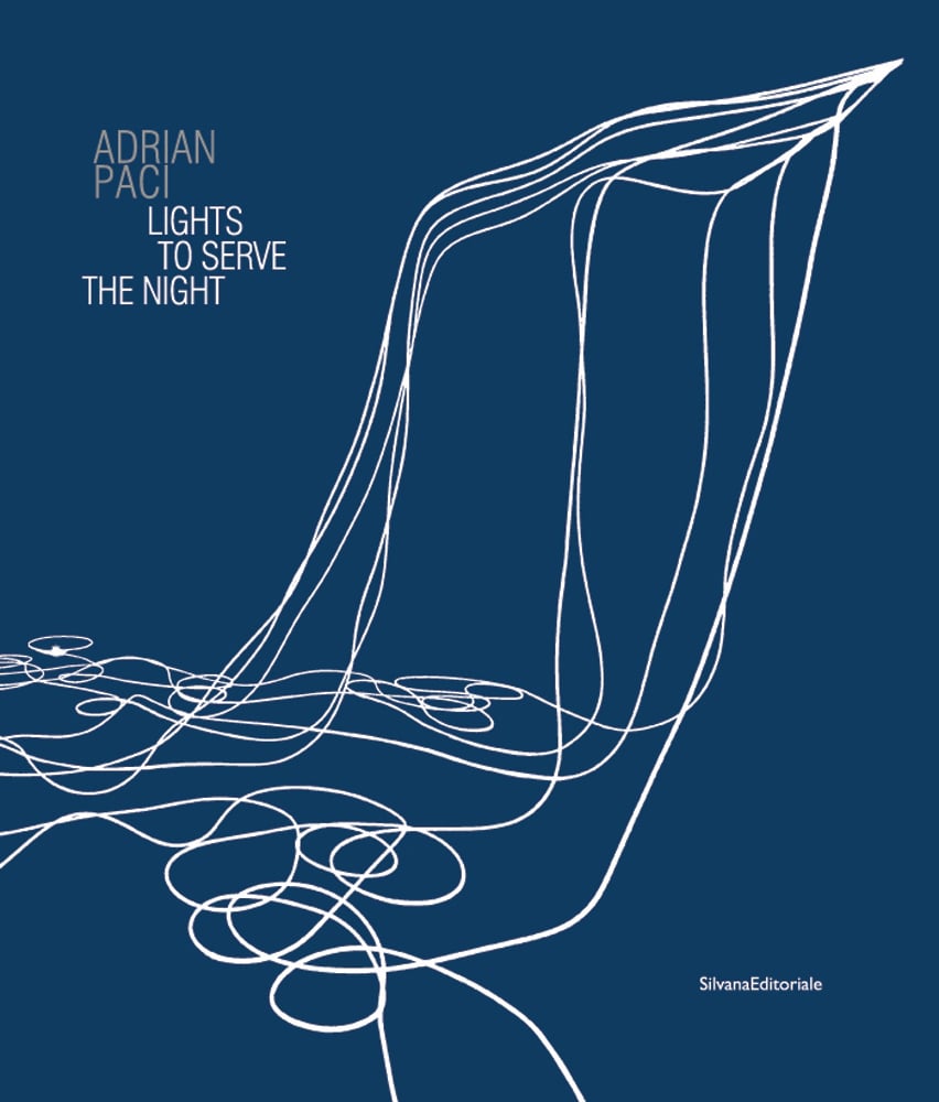 Book cover of Adrian Paci: Lights to Serve the Night, with white wires cascading down, curled on floor. Published by Silvana.