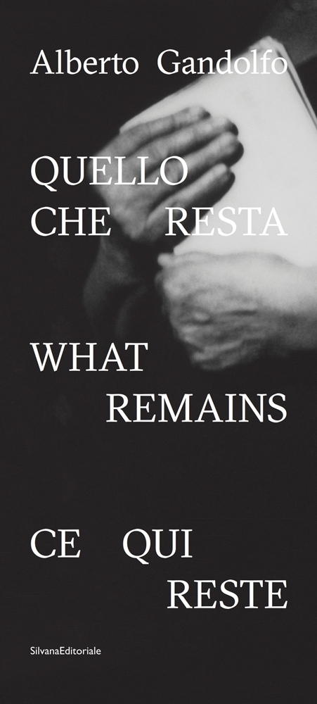 Book cover of Alberto Gandolfo: What Remains, with a pair of hands clutching papers. Published by Silvana.