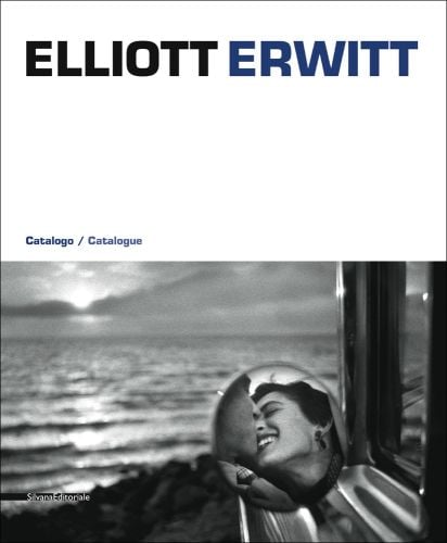 Reflection of couple kissing in round car side mirror, seascape behind, ELLIOTT ERWITT in black and navy font on white banner above