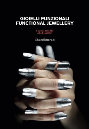 Pair of hands, fingers interlaced, metal cover to index finger, silver paint to tips, black cover, FUNCTIONAL JEWELLERY in white font above