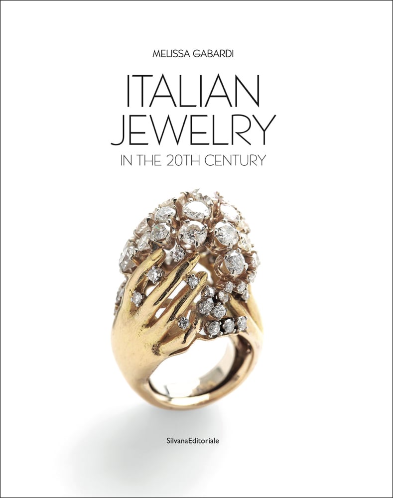 Diamond encrusted gold ring in shape of pair of hands, white cover, ITALIAN JEWELRY IN THE 20TH CENTURY font above.
