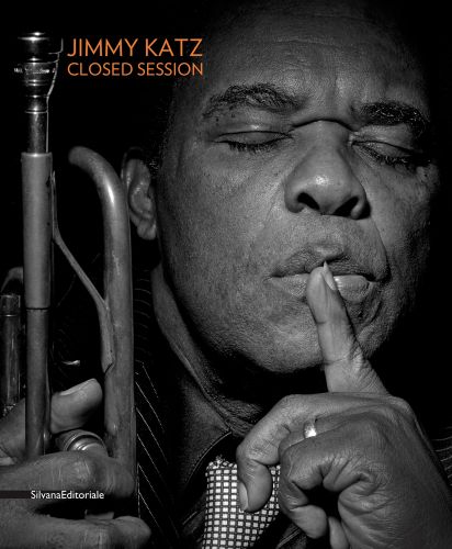 Louie Armstrong with eyes closed, holding trumpet in right hand, left index finger to mouth, JIMMY KATZ CLOSED SESSION in orange font to upper left.