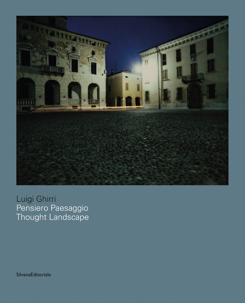City square with buildings under night sky, blue cover, Luigi Ghirri Thought Landscapes in blue and white font above