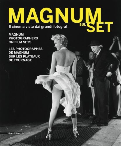 Marilyn Monroe on The Seven Year Itch film set, in white dress, skirt blowing up, MAGNUM SUL SET in yellow font above.
