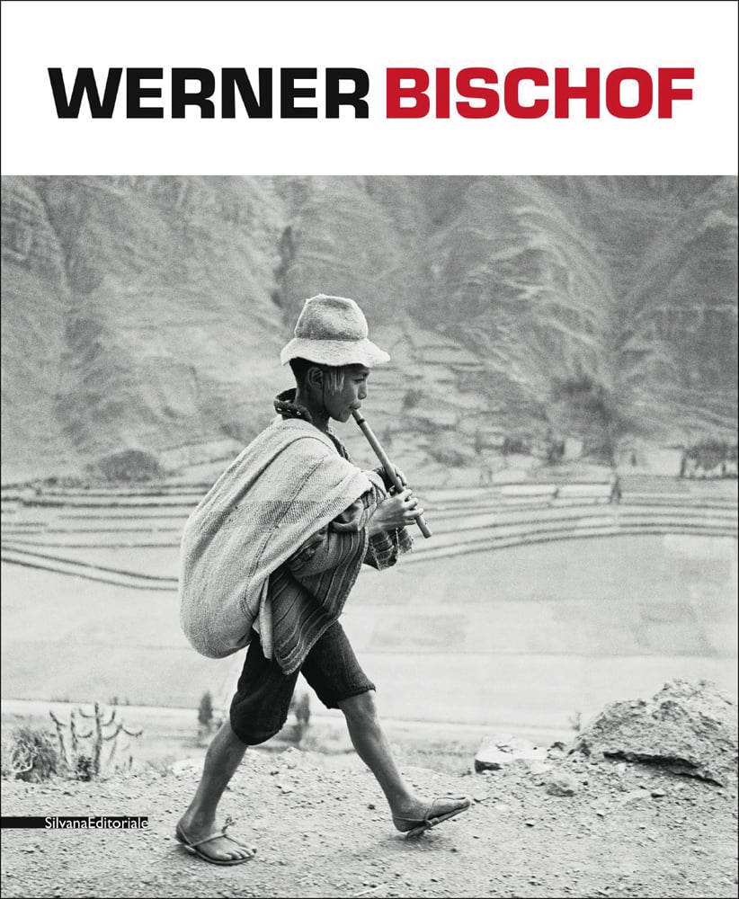 Peruvian boy playing the quena on the road to Cuzco, on mountain side, WERNER BISCHOF in black and red font on white top banner