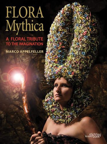 Book cover of Flora Mythica, A Floral Tribute to the Imagination, featuring a woman wearing a large arrangement of flowers on head, holding an illuminated cane. Published by Stichting.