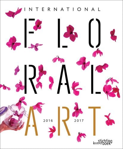 White book cover of International Floral Art 2016/2017, with a person's hand throwing a glass Kilner jug of pink flower petals in the air. Published by Stichting.
