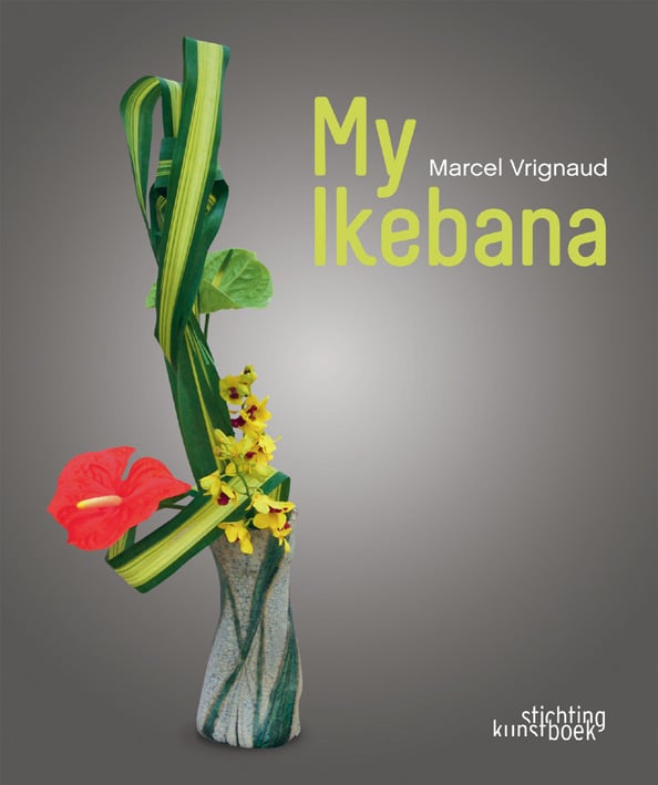 Grey book cover of My Ikebana, with a flower arrangement of long, green strap leaves with a red Anthurium flower. Published by Stichting.