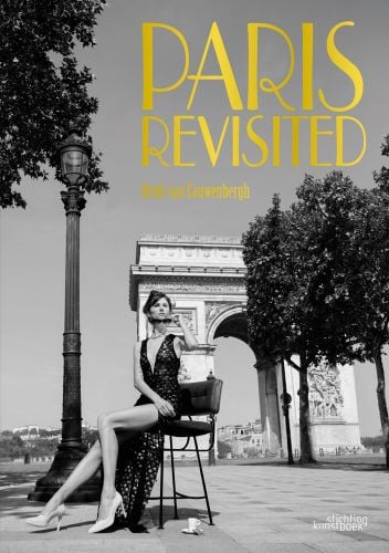 Model in long black plunging dress, perched on stool in front on d'arc de triomphe, Paris Revisited in shiny bright gold font above