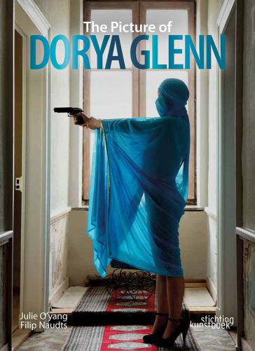 Julie O'yang as Dorya Glenn wrapped in turquoise cloth, pointing gun at open door, The Picture of Dorya Glenn in white and turquoise font