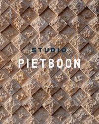 Textured diamond brick wall, on cover of 'Piet Boon: Studio', by Lannoo Publishers.