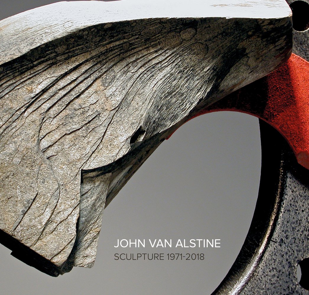 Close up slate textured piece of grey sculpture, grey cover, JOHN VAN ALSTINE SCULPTURE 1971-2018 in white and brown font below.