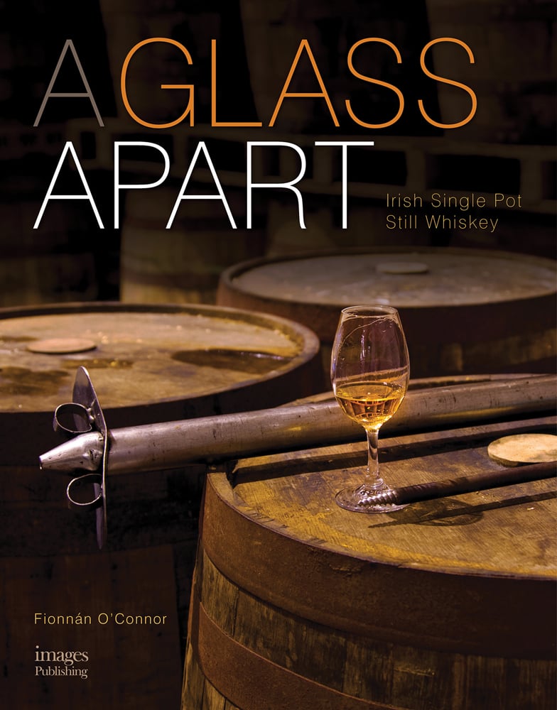 Book cover of Fionnan O'Connor's A Glass Apart: Irish Single Pot Still Whiskey, with a glass of whiskey on top of barrel. Published by Images Publishing.