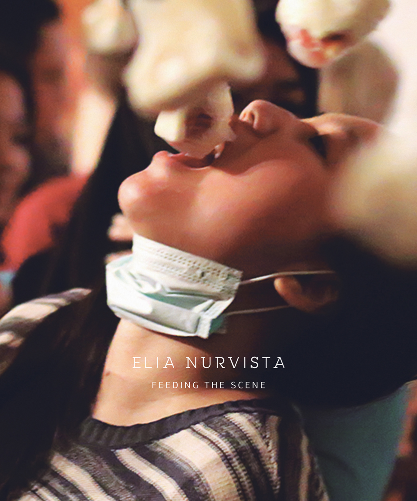 Book cover of Elia Nurvista, Feeding the Scene, with young person throwing head back with mouth open, object dangling above mouth, and surgical mask under chin. Published by Verlag Kettler.