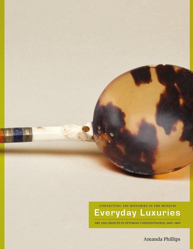 Book cover of Everyday Luxuries, with a tortoise shell spoon, with white and gold handle. Published by Verlag Kettler.
