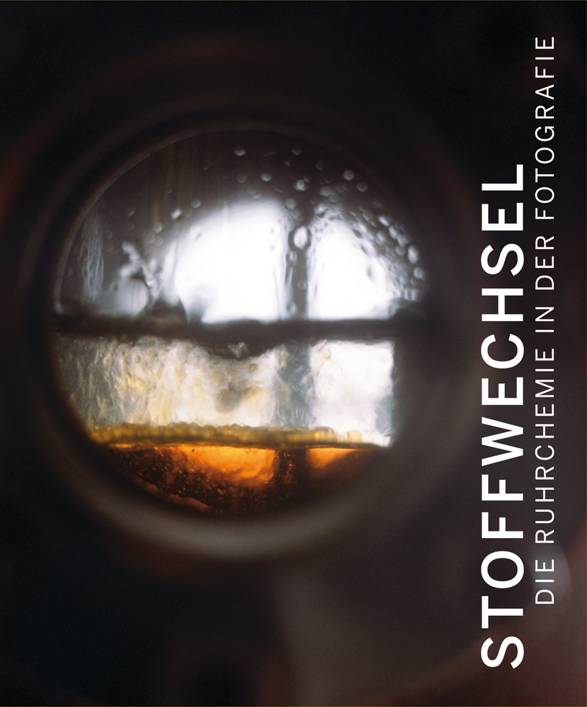 Book cover of Metabolic Processes, Ruhrchemie in Photography, with a window to chemical metal vat, with amber liquid inside. Published by Verlag Kettler.