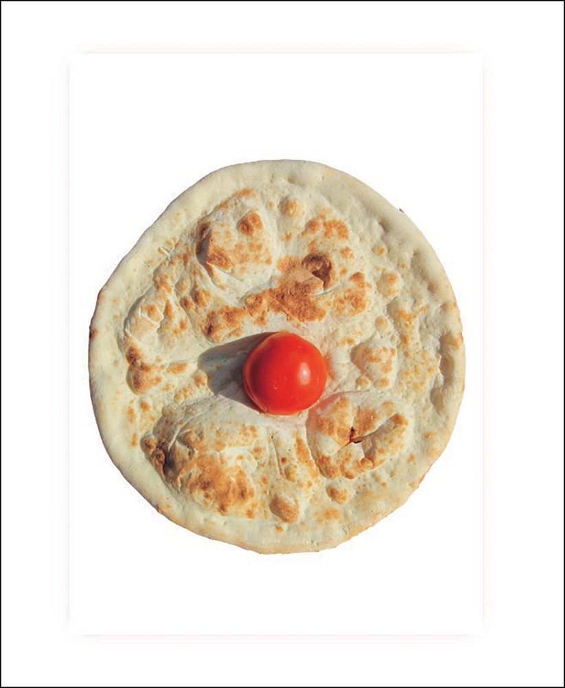 Circular plain pizza with tomato in centre on white cover with feint pink border and inch from cover edge