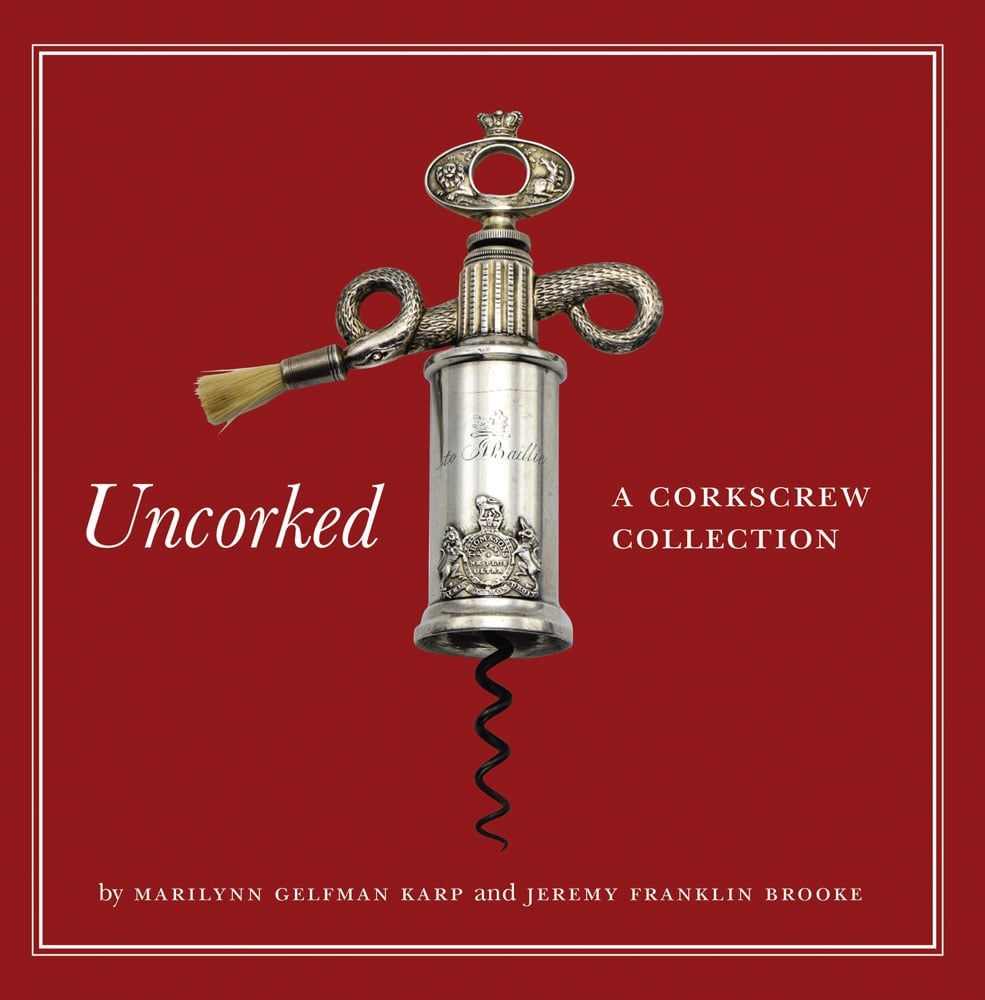 Silver antique serpent variant corkscrew, on dark red cover, Uncorked A CORKSCREW COLLECTION in white font to centre left and right.