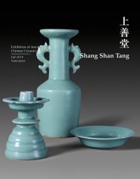 Three pieces of pale turquoise ceramic pieces, candle holder, vessel and plate, on grey cover of 'Shang Shan Tang, Exhibition of Ancient Chinese Ceramics 20 items', by CA Publishing.