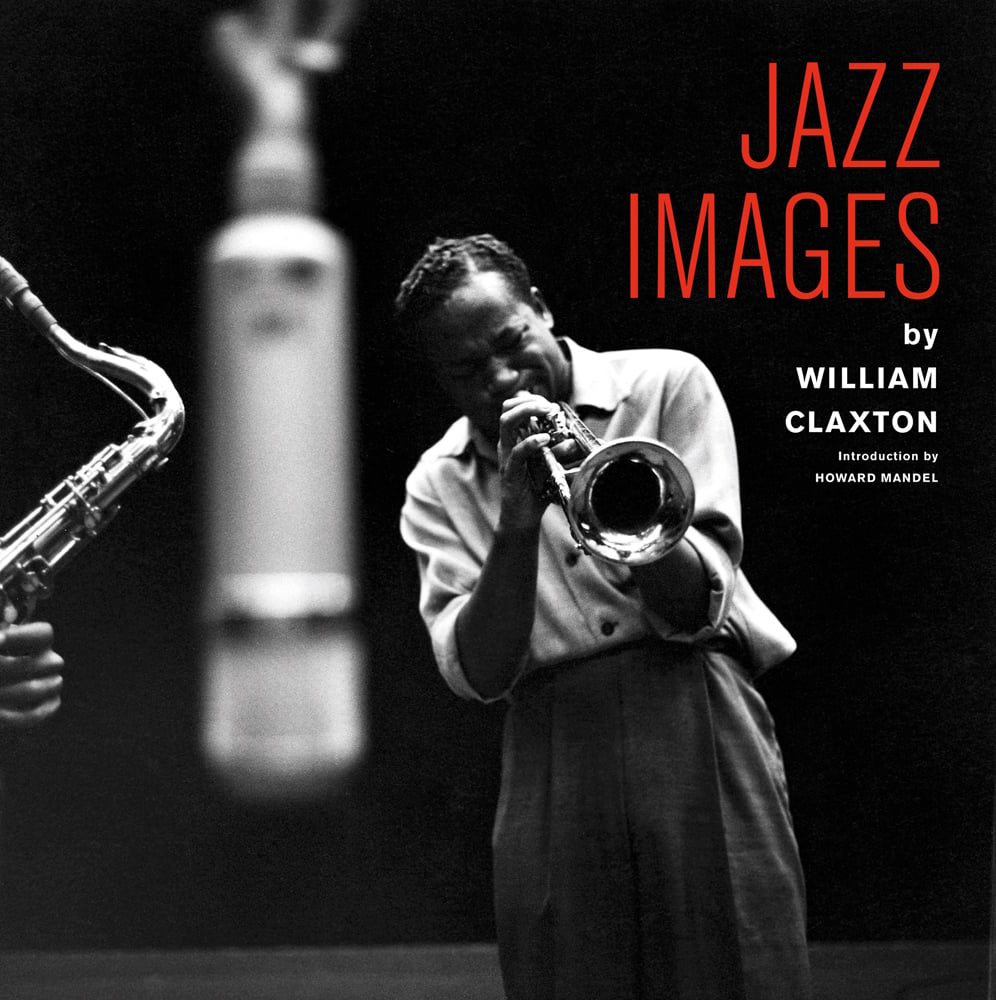 Jazz musician Louis Armstrong playing his trumpet in studio, blurred microphone in front, black cover, JAZZ IMAGES BY WILLIAM CLAXTON in red and white font to upper right.