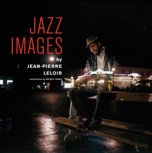 Jazz trumpeter Donald Byrd sitting on bench at night, reading newspaper, illuminated building behind layered over top, JAZZ IMAGES BY JEAN-PIERRE LELOIR in red and white font to upper left.