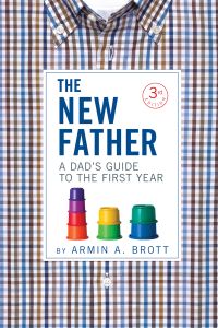 Blue and brown checked shirt THE NEW FATHER A DAD'S GUIDE TO THE FIRST YEAR in blue and grey font to centre of white banner, 3rd Edition to circle in red font.