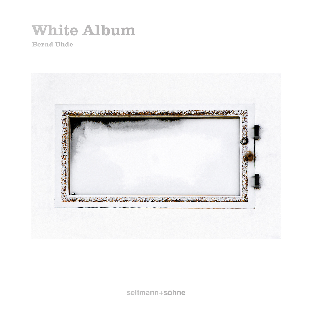 Book cover of White Album: The colours of snow, with an aerial view of a snow covered object. Published by Seltmann Publishers.