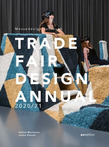Two women wearing virtual reality headsets, on geometric pattered platform, on cover of 'Trade Fair Annual 2020/21, The Standard Reference Work in the Trade Fair Design World', by Avedition Gmbh.