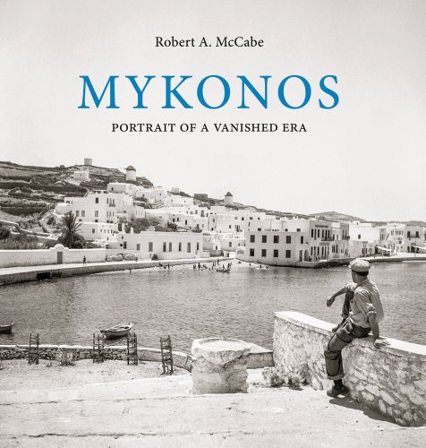 Sepia landscape of Mykonos, male sitting on wall looking out to harbour, white buildings in distance, MYKONOS PORTRAIT OF A VANISHED ERA in blue, and black font above.