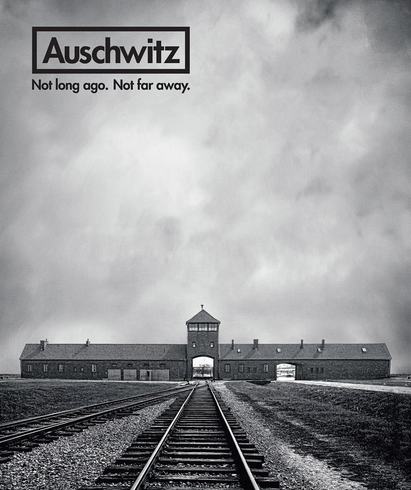 Book cover of Auschwitz: Not Long Ago. Not Far Away, with the train tracks heading towards the Auschwitz II (Birkenau) concentration camp. Published by Abbeville Press.