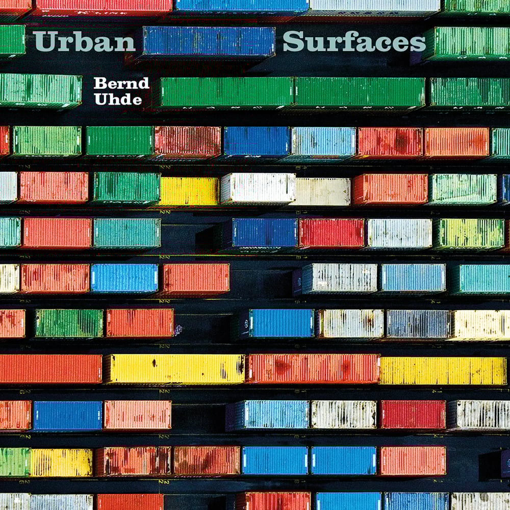 Book cover of Urban Surfaces, with an aerial view of lines of colorful metal lorry containers. Published by Seltmann Publishers.