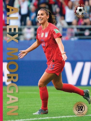 Female footballer Alex Morgan in red kit, celebrating scoring a goal, Alex Morgan, in gold font down left edge, by Abbeville Press.