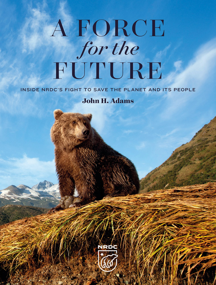 Book cover of A Force for the Future: Inside NRDC's Fight to Save the Planet and Its People, with a large brown bear sitting on top of grassy mound, with mountainous landscape behind. Published by Abbeville Press.