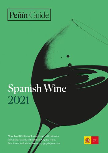 Wine glass with wine being swilled around, on green cover of 'Peñin Guide Spanish Wine 2021', by Grupo Penin.
