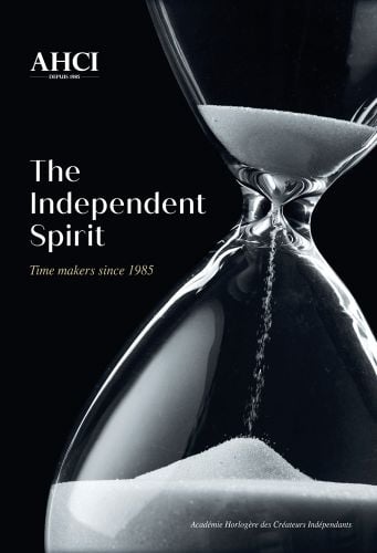Hourglass with beads of white falling through, black cover AHCI The Independent Spirit in white font to upper left.