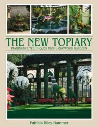 Longwood garden conservatory with topiary giraffes, on cover of 'New Topiary, Imaginative Techniques from Longwood Gardens', by ACC Art Books.