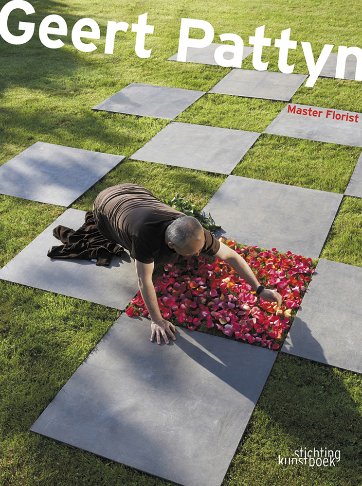 Book cover of Geert Pattyn, Master Florist, with man placing pink flower petals on square patch of grass, with grey slabs in check pattern. Published by Stichting.