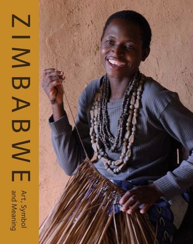 African girl smiling while threading a grass skirt, ZIMBABWE Art, Symbol and Meaning in brown font down left yellow edge.