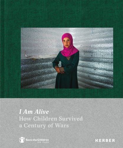 Child in pink headscarf and green dress with hands on right hip, jade green cover, I Am Alive How Children Survived a Century of Wars on grey banner below in white font